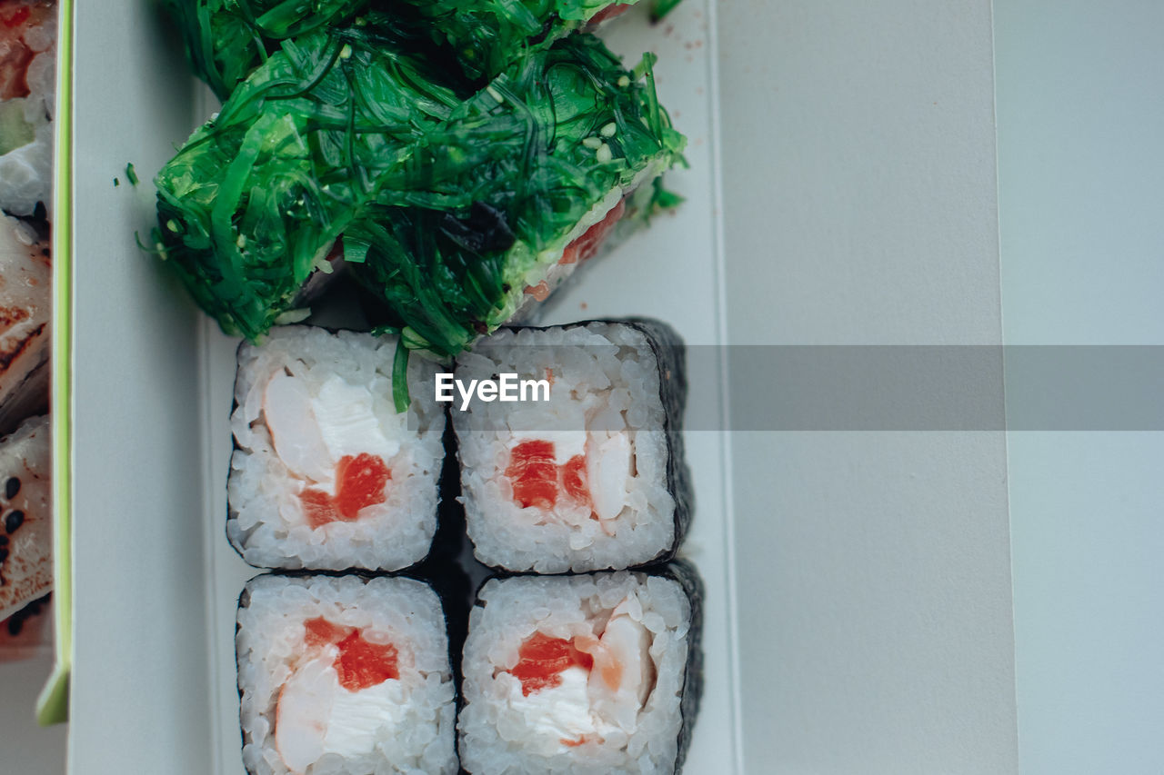 food and drink, food, freshness, healthy eating, cuisine, wellbeing, seafood, no people, indoors, dish, california roll, sushi, asian food, japanese food, rice, still life, meal, directly above, japanese cuisine, high angle view, raw food, fish, gimbap, culture, close-up