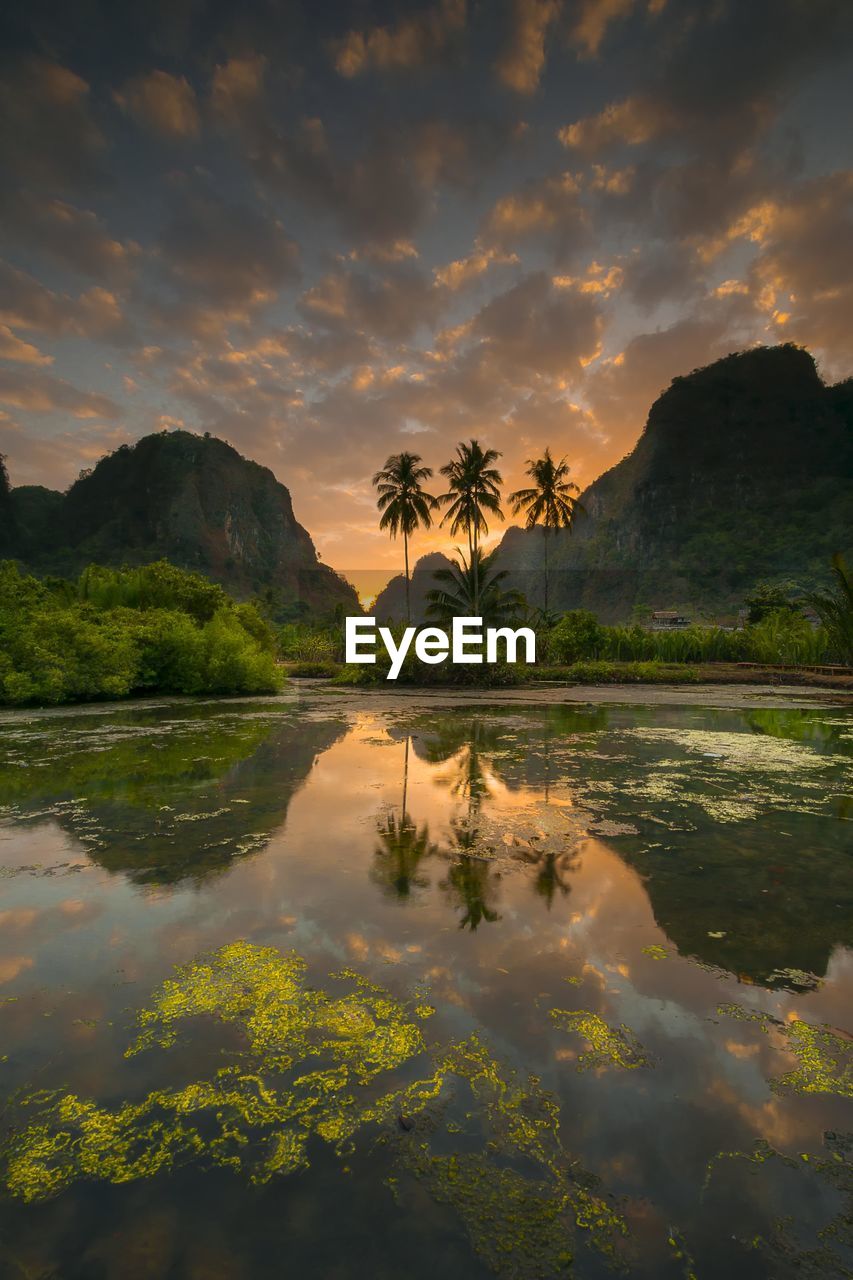 Scenic view of lake against sky during sunset