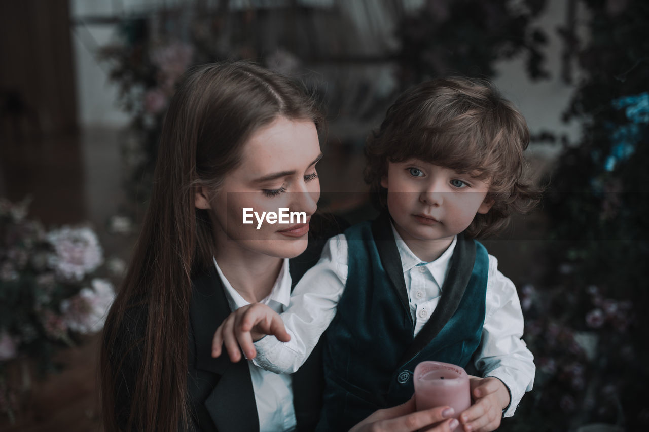 Portrait of mother and girl looking at camera