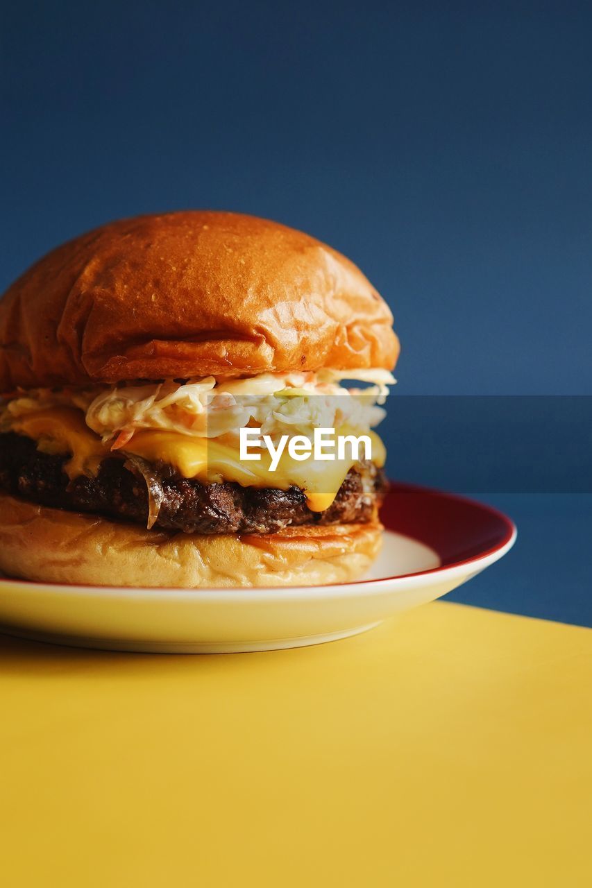 Close-up of cheeseburger on table