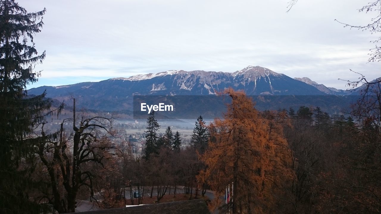 Scenic view of field and mountains against sky