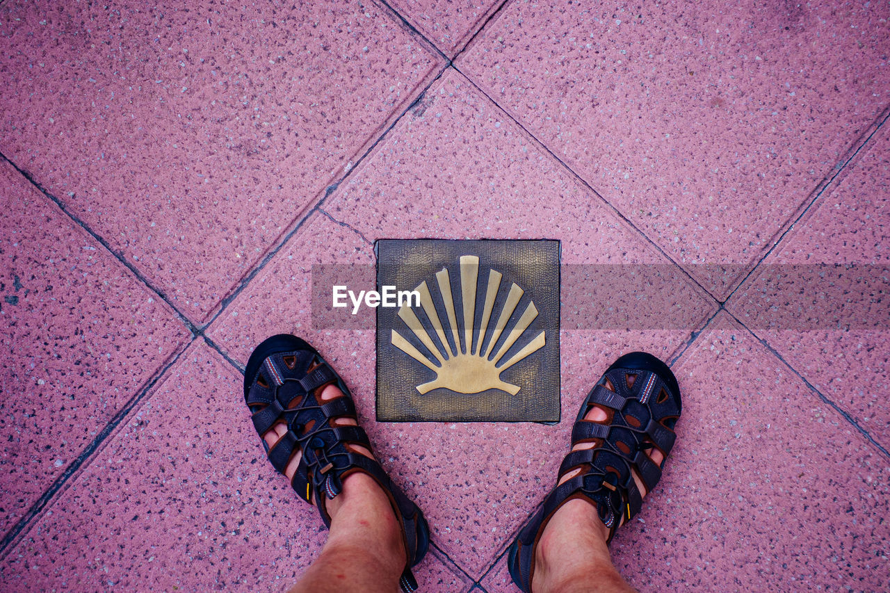 Low section of person standing on tiled floor