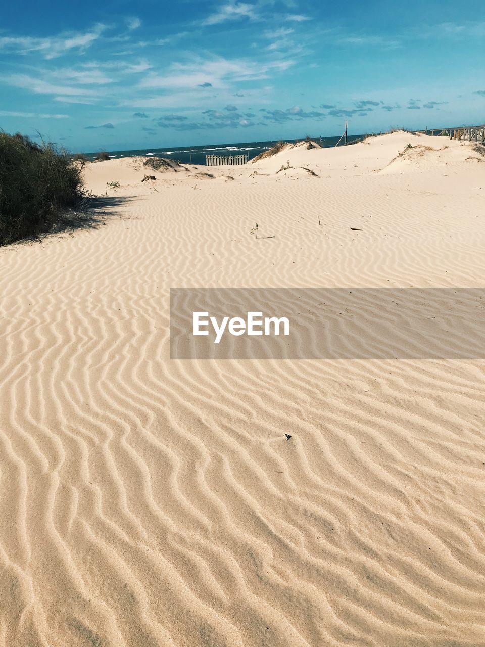 Sand dunes in desert against sky