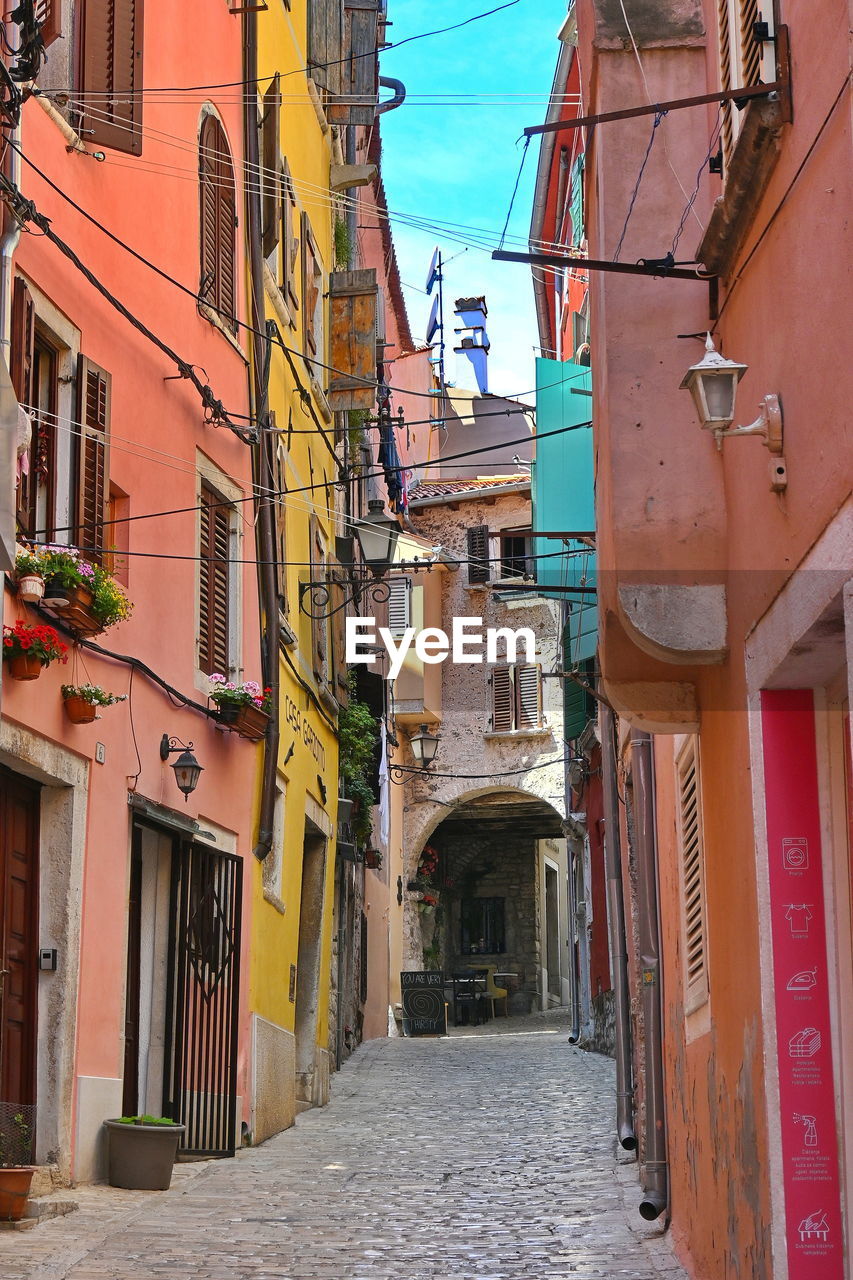 Street amidst buildings in city. old town of rovinj, croatia