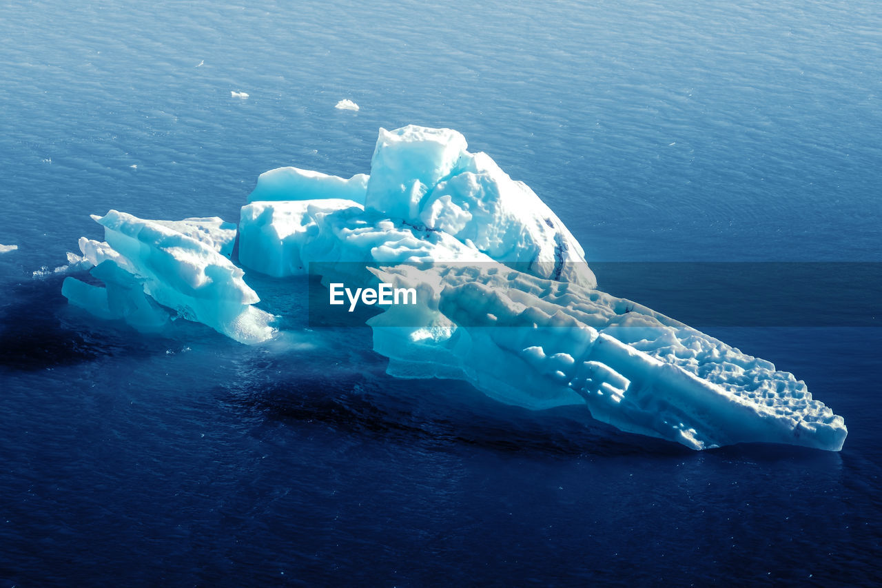 Aerial view of iceberg floating on sea