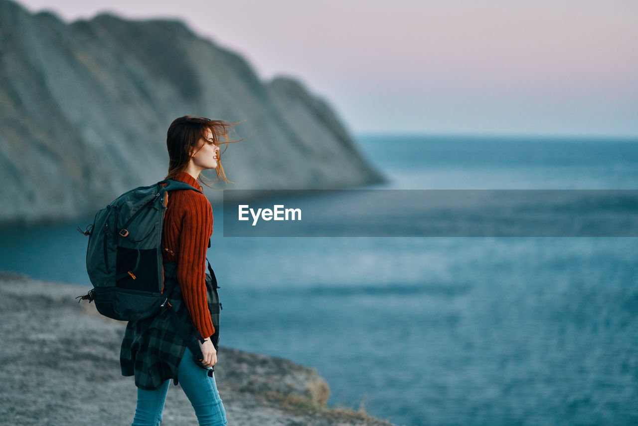 Man looking at sea against sky