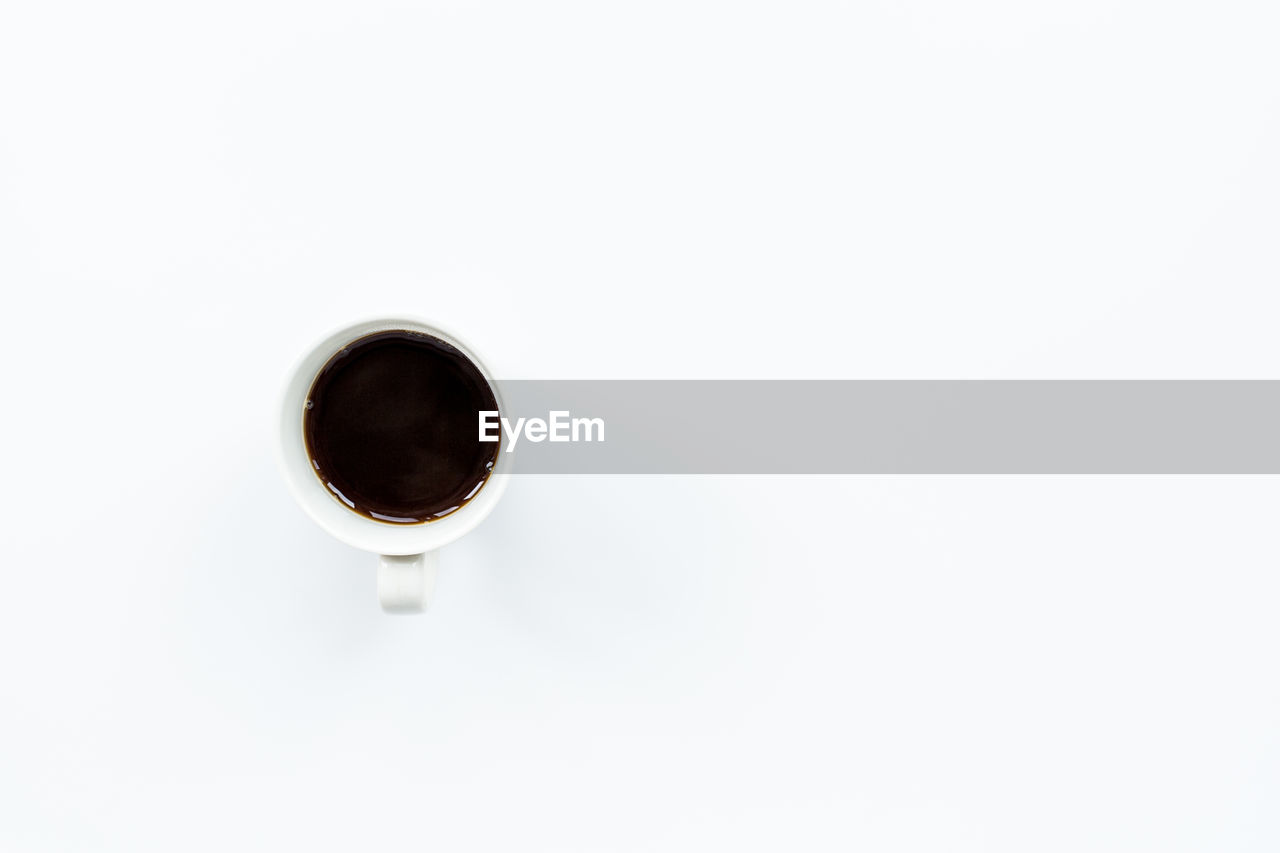 High angle view of coffee in cup on white background