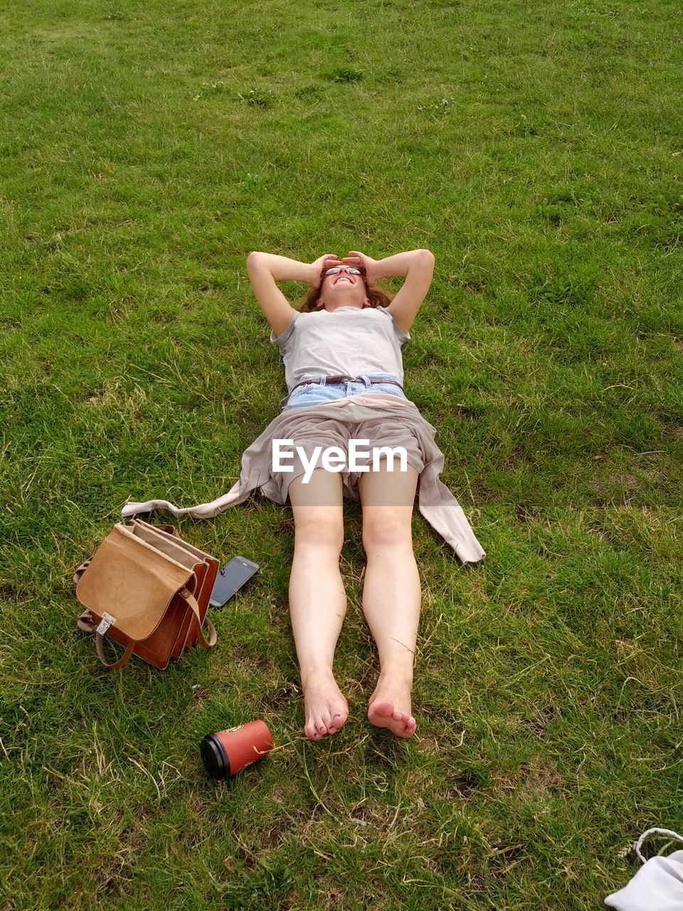 High angle view of a woman lying on grass