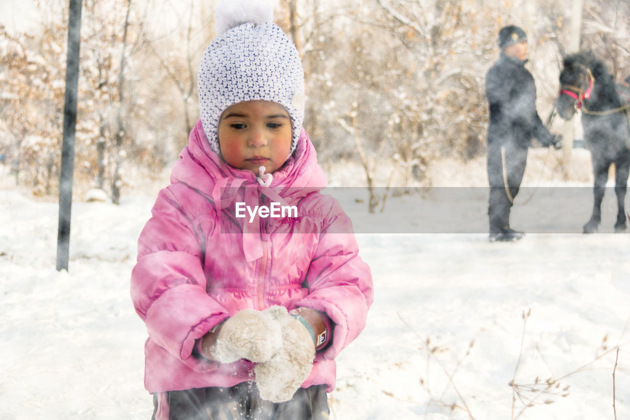 Cute girl standing in snow