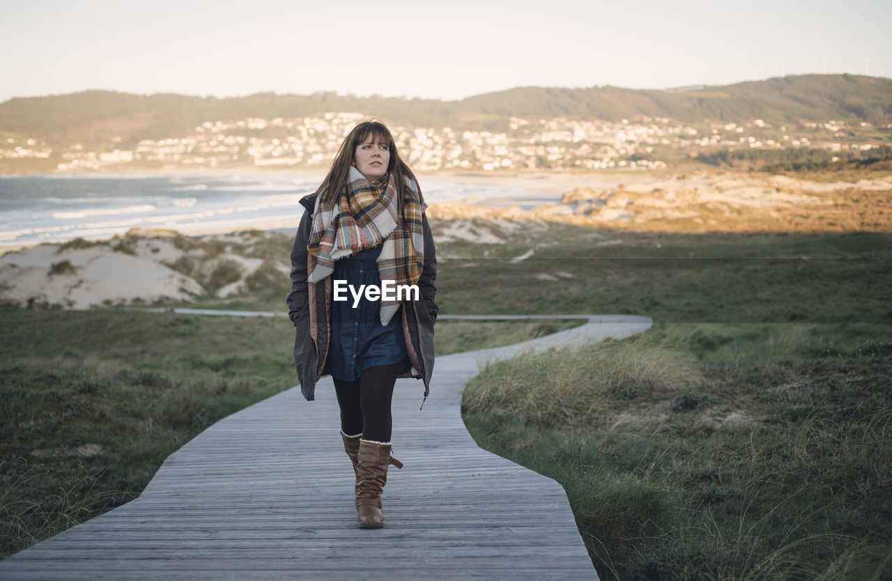 Full length of woman standing on beach