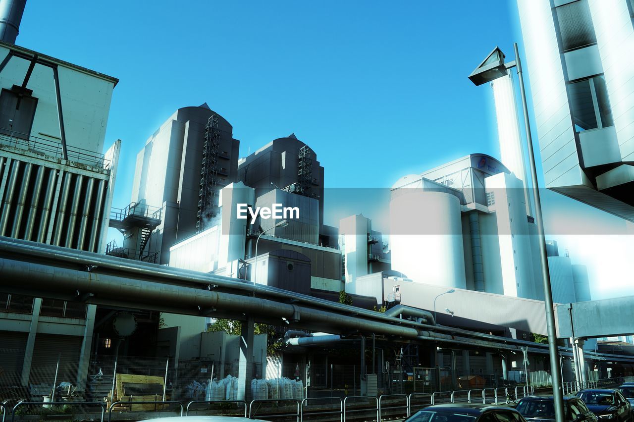 LOW ANGLE VIEW OF OFFICE BUILDINGS AGAINST CLEAR BLUE SKY