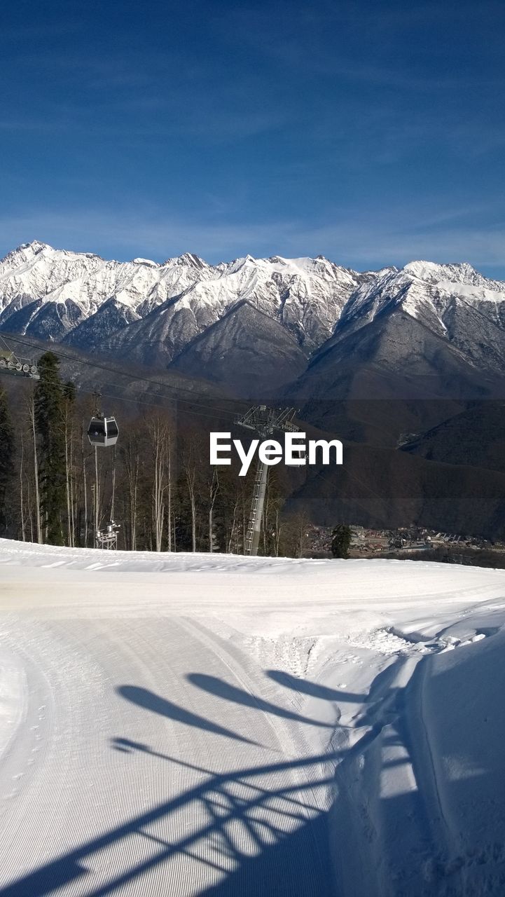 Scenic view of snow covered mountains against sky