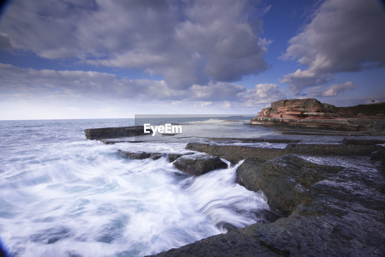 Scenic view of sea against cloudy sky