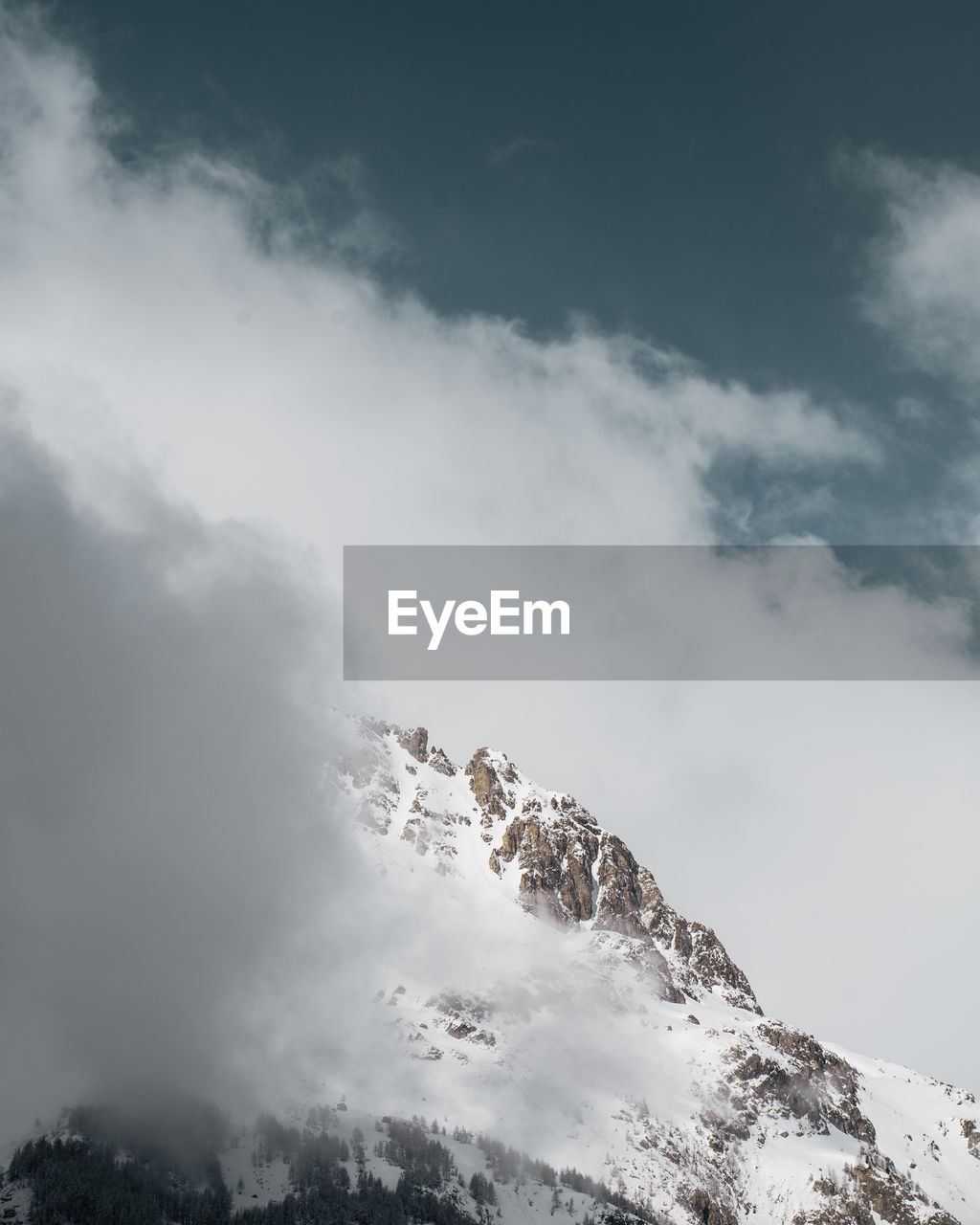 Low angle view of snowcapped mountain against sky