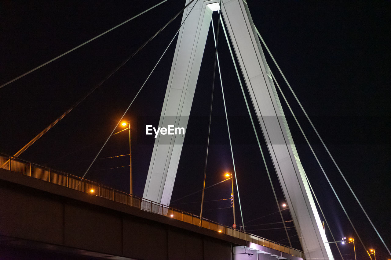 LOW ANGLE VIEW OF BRIDGE AT NIGHT