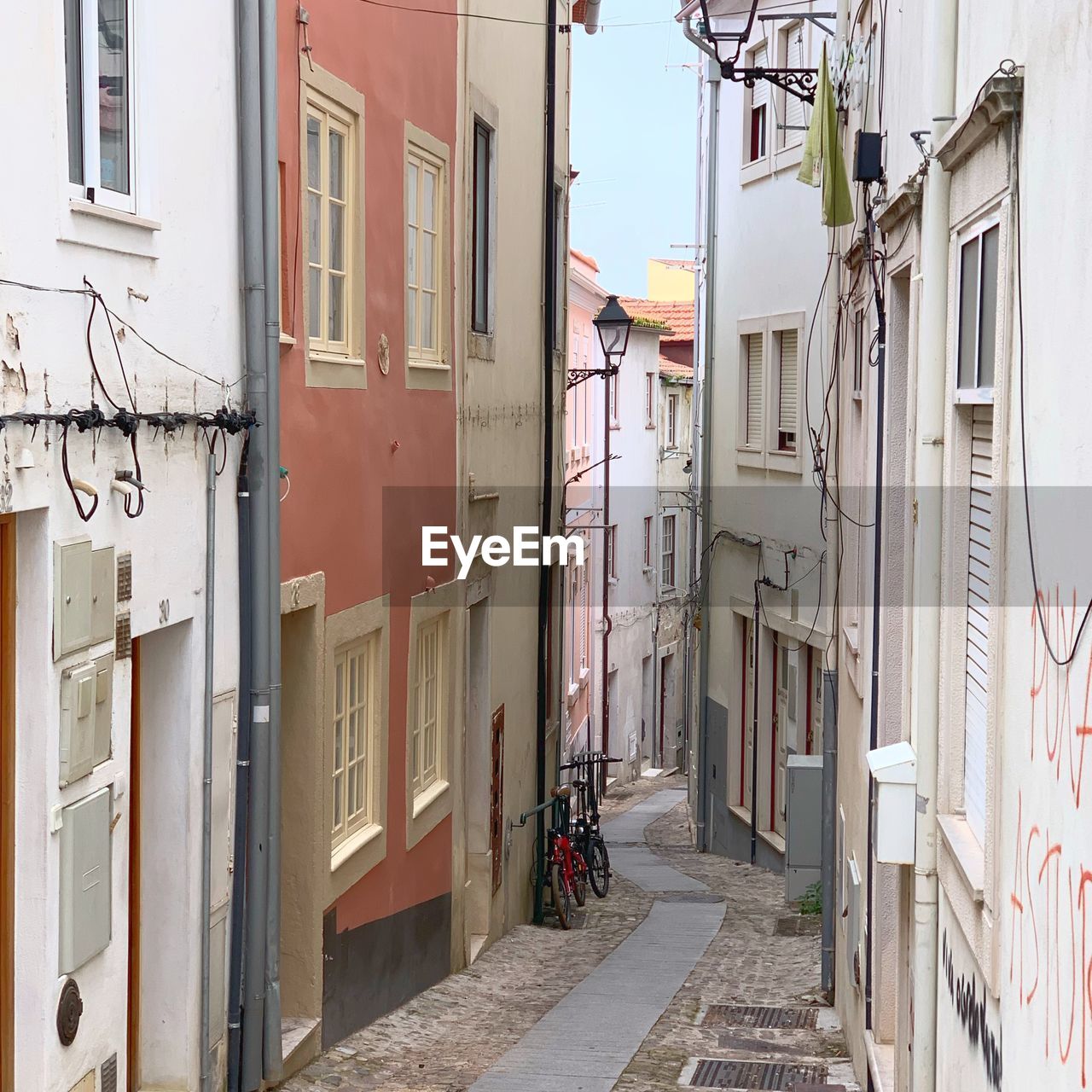 Narrow street amidst buildings in city