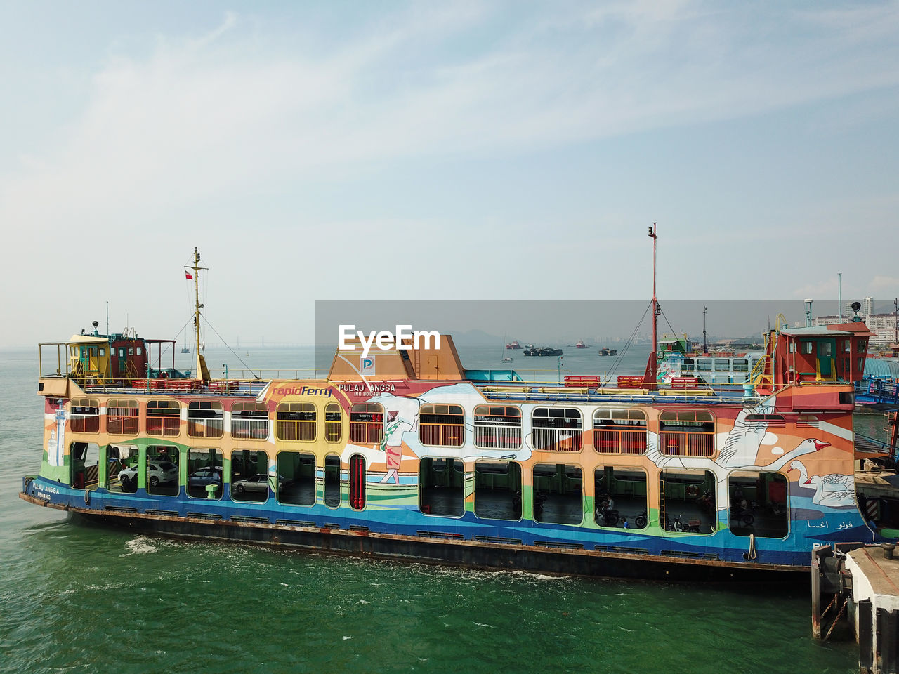 BOATS MOORED IN SEA AGAINST SKY