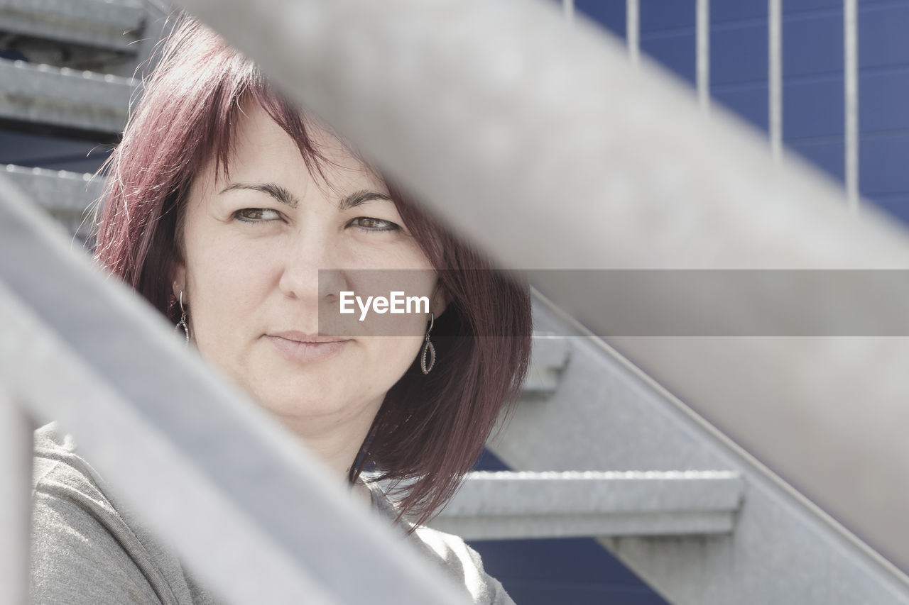 Close-up of smiling woman looking away