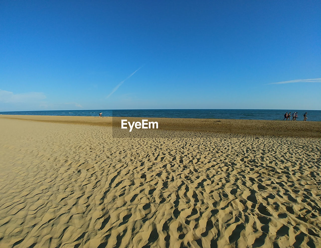 SCENIC VIEW OF BEACH AGAINST BLUE SKY