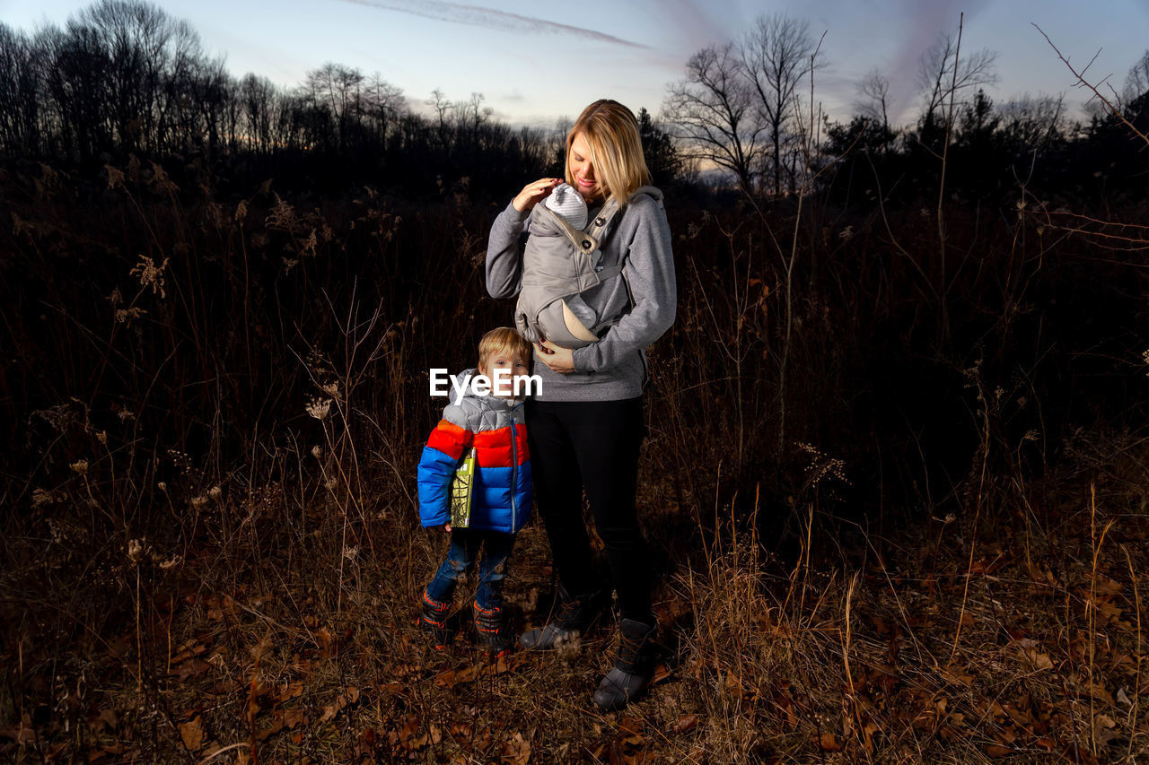 SIBLINGS STANDING ON FIELD