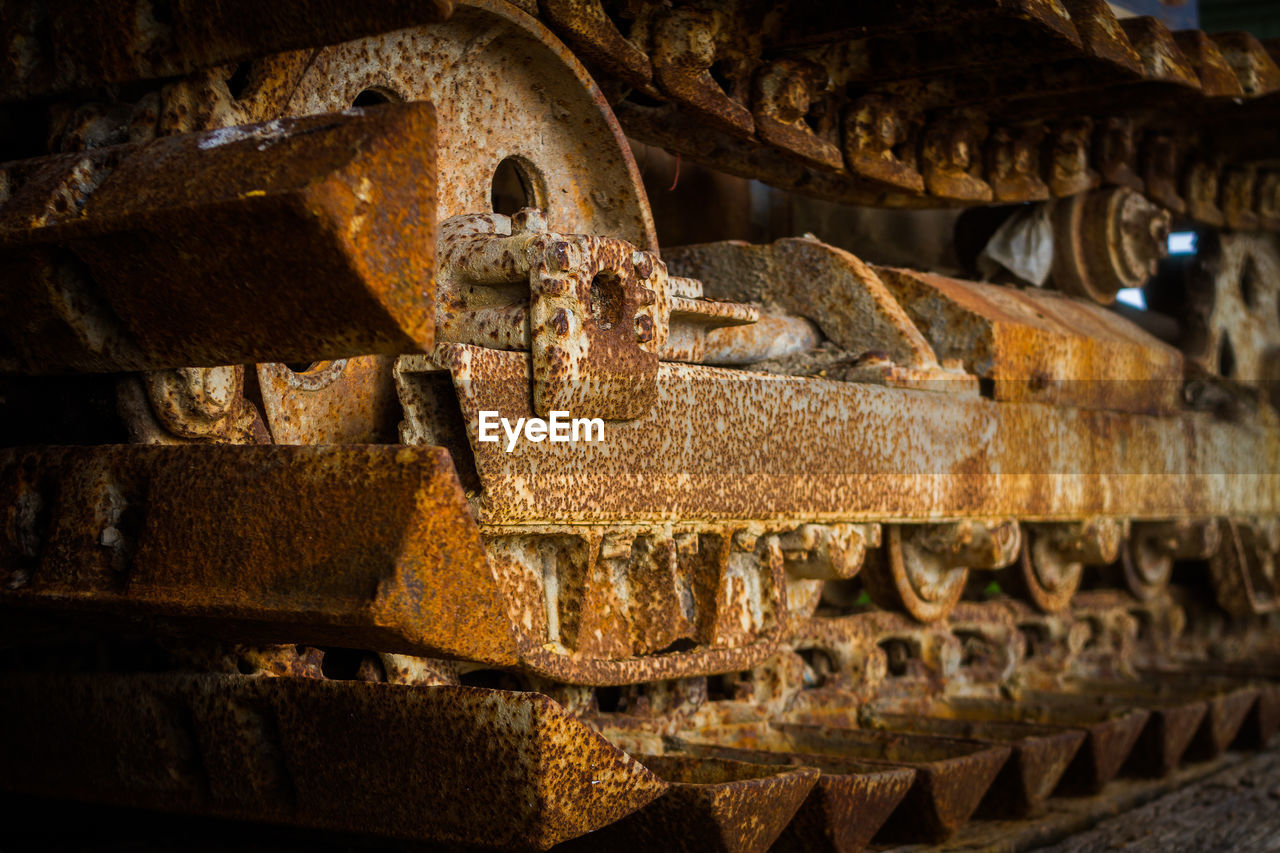 Close-up of old rusty metal bulldozer wheel 