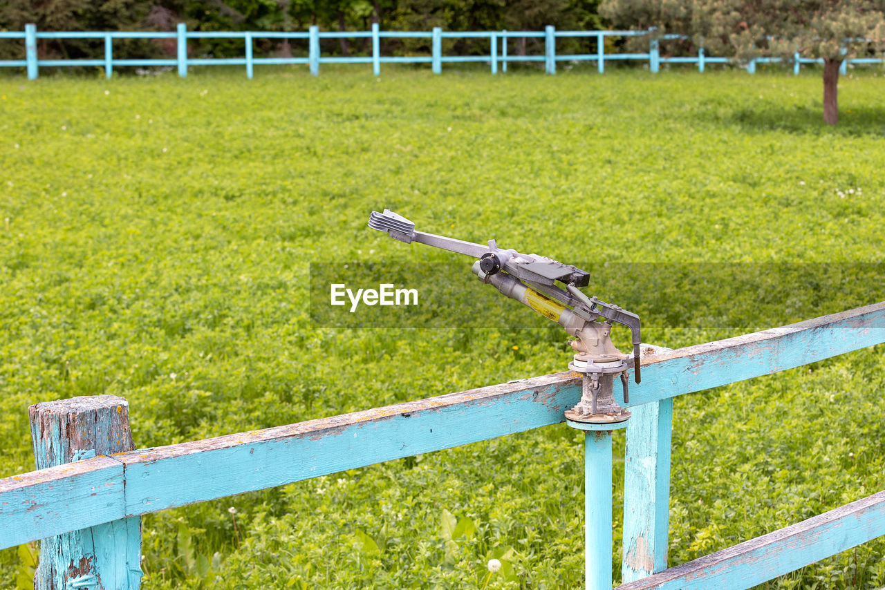 grass, plant, field, green, nature, fence, day, no people, agriculture, land, lawn, metal, outdoors, railing, bicycle, growth, home fencing, playground, sunlight, security, split-rail fence