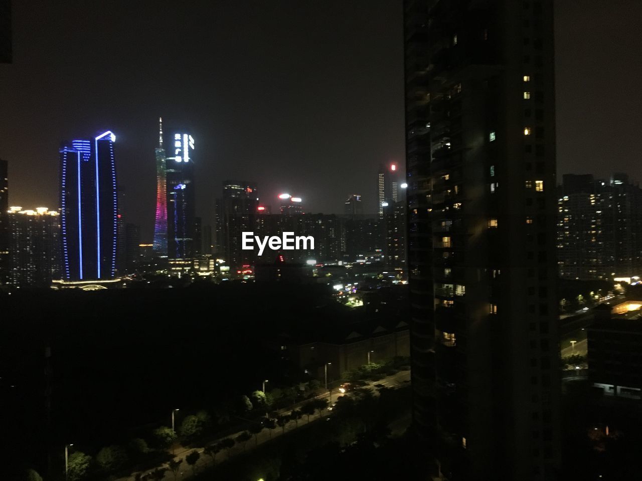 ILLUMINATED CITYSCAPE AGAINST SKY