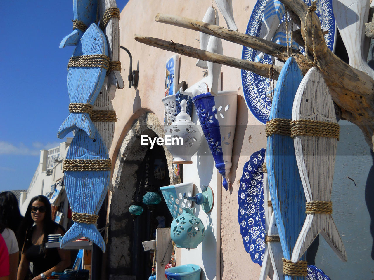 LOW ANGLE VIEW OF CLOTHES HANGING AT MARKET