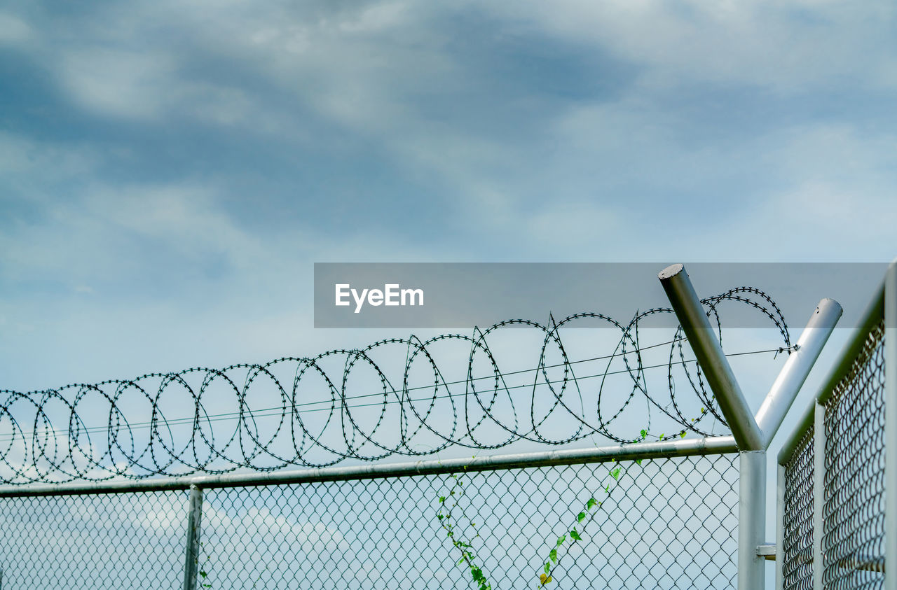 Prison security fence. barbed wire security fence. razor wire jail fence. barrier border. boundary.