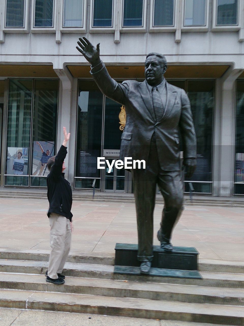 Man looking at sculpture