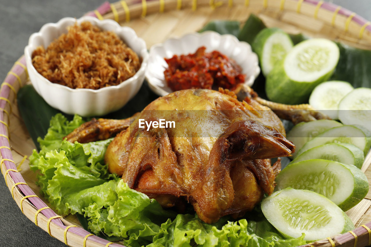 Ayam goreng lengkuas, fried whole chicken with shredded galangal serundeng and spicy sambal