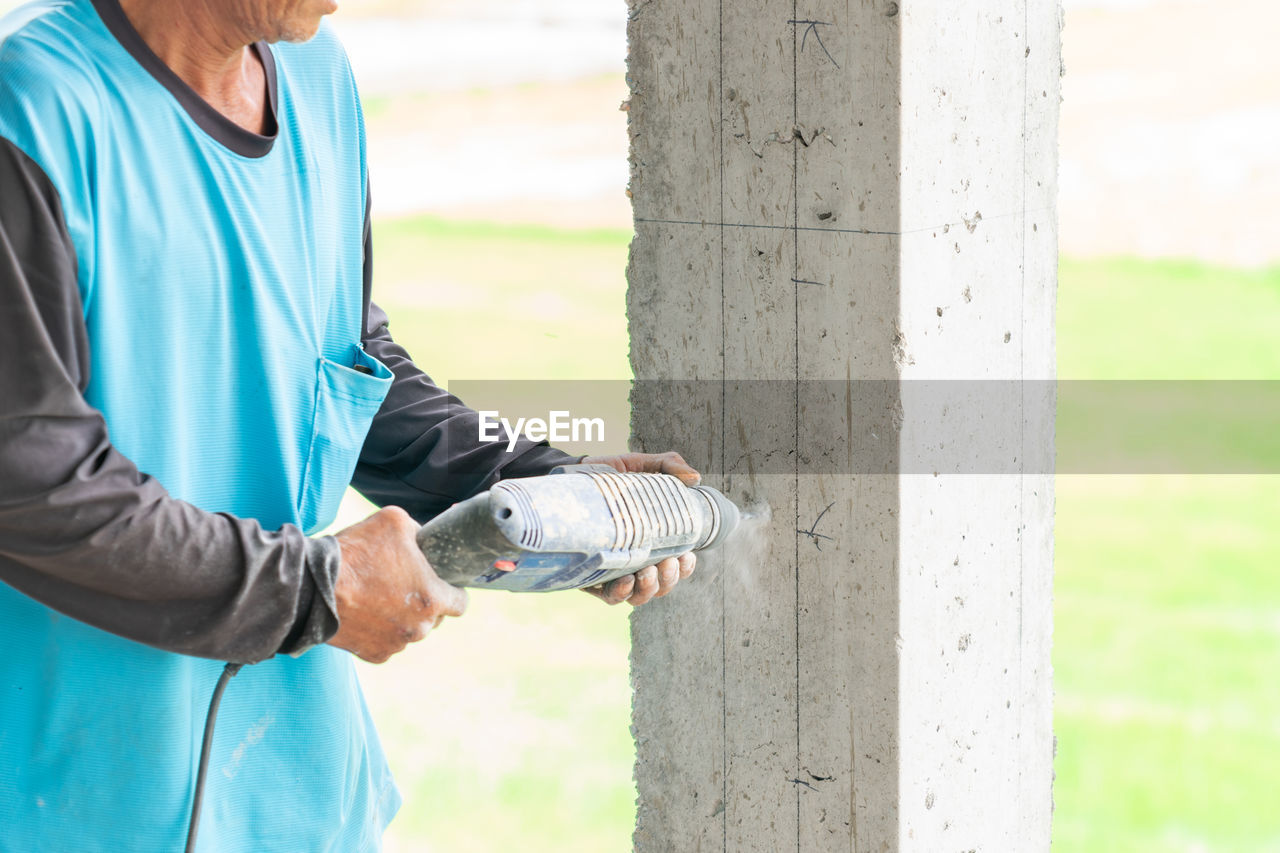 adult, spring, one person, lifestyles, blue, men, day, standing, nature, senior adult, sports, outdoors, casual clothing, women, leisure activity, tree trunk, sports clothing, clothing, focus on foreground, trunk, sleeve, relaxation, activity, holding, seniors, mature adult, exercising