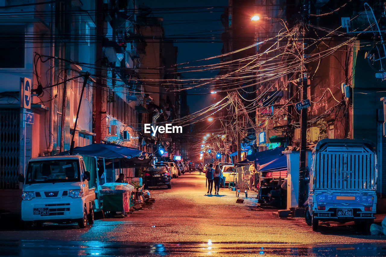 Illuminated city street at night