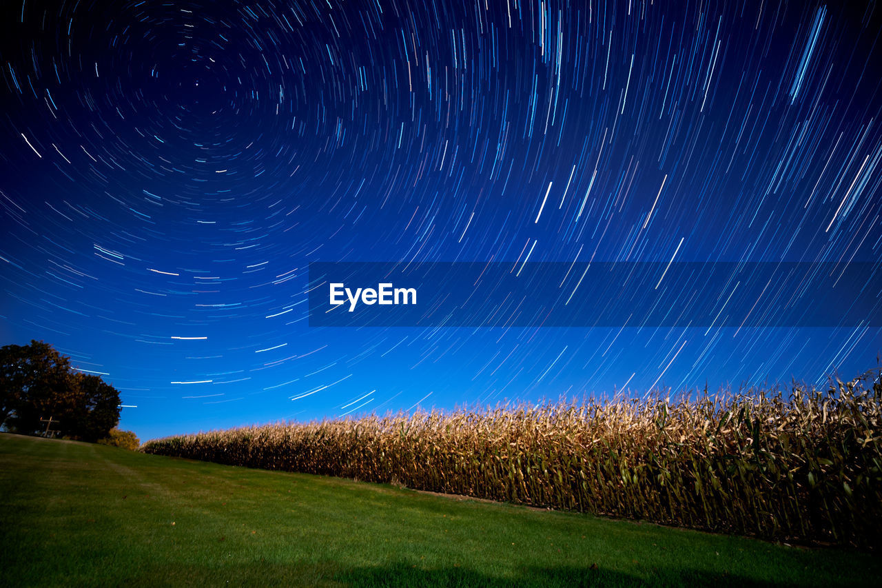 Scenic view of field against sky at night