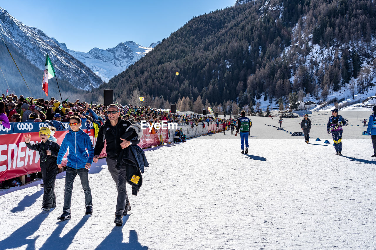 PEOPLE ON SNOW COVERED MOUNTAIN