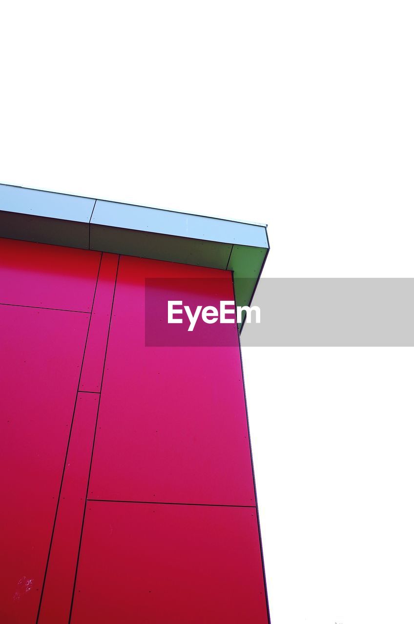 Low angle view of pink building against clear sky
