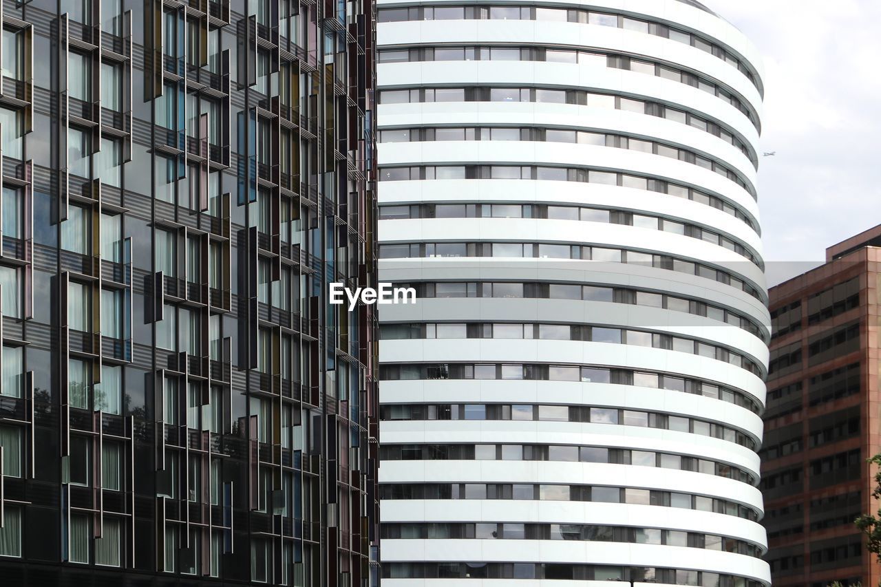 Low angle view of modern building in city against sky