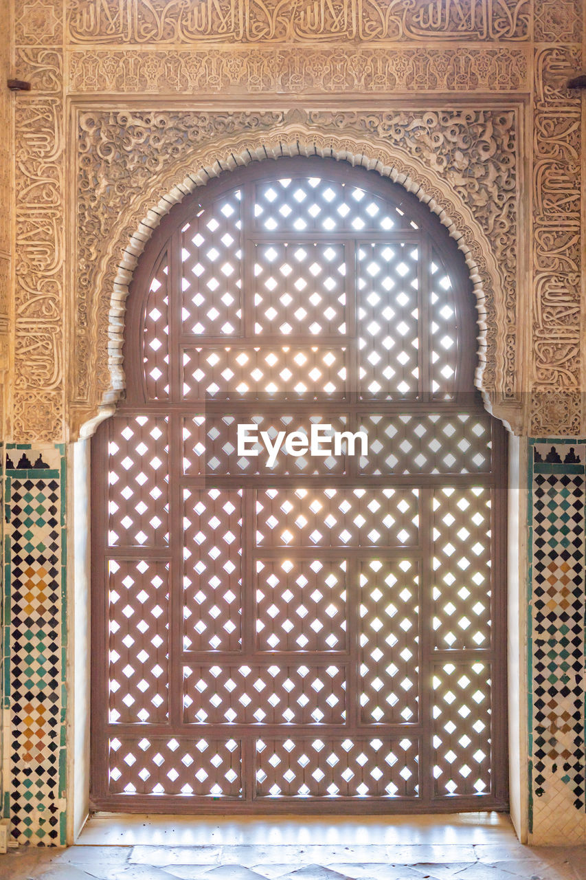 Arabesque lattice window in the alhambra of granada