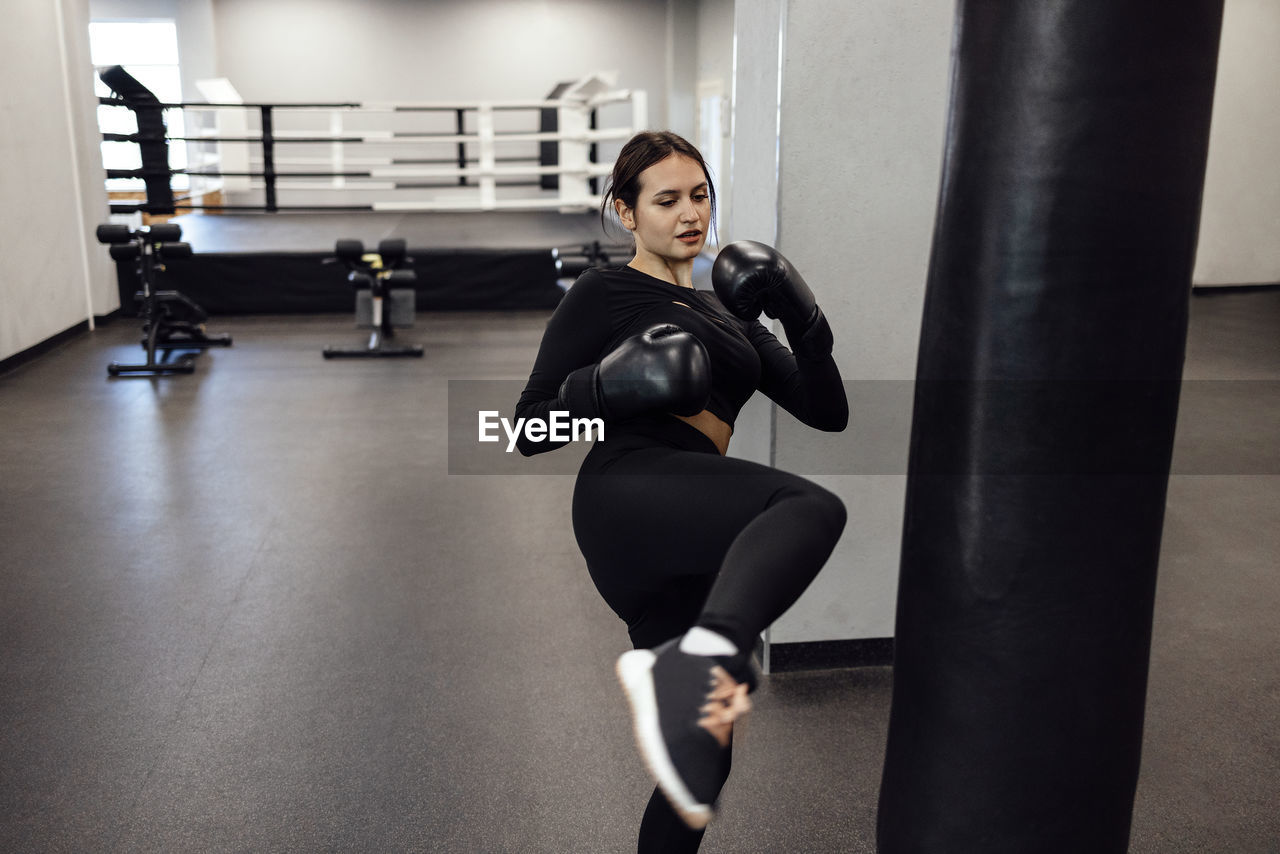 low section of woman exercising in gym