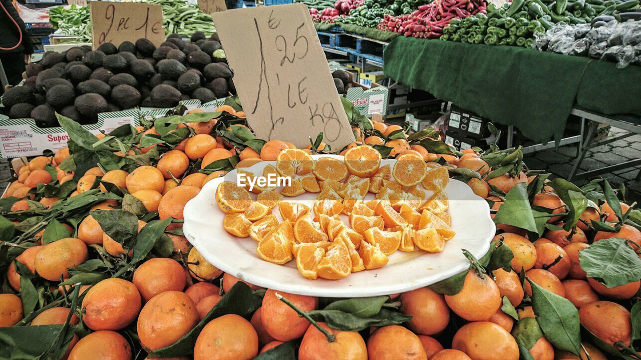 High angle view of fresh organic oranges with label at market stall