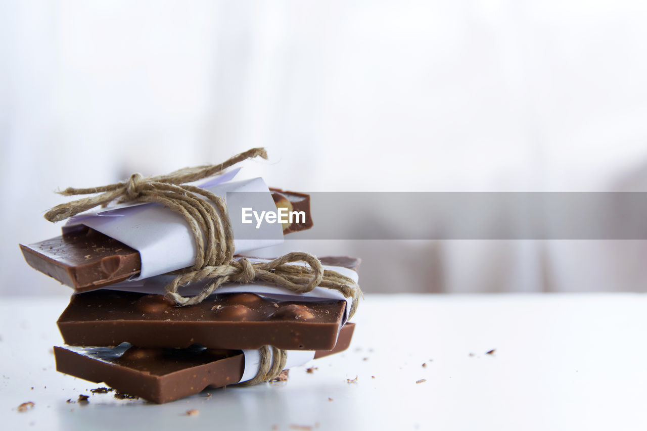 CLOSE-UP OF CHOCOLATE ON TABLE AT HOME