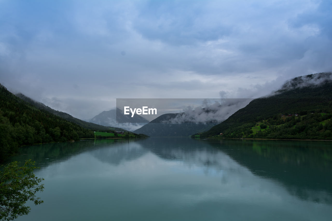 Scenic view of lake and mountains against sky