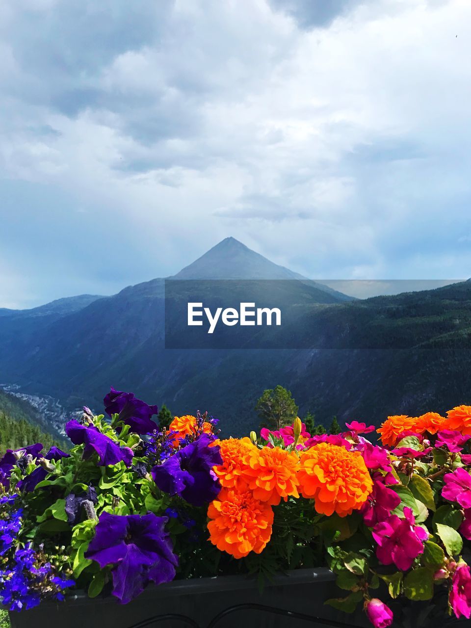 Scenic view of mountains against cloudy sky