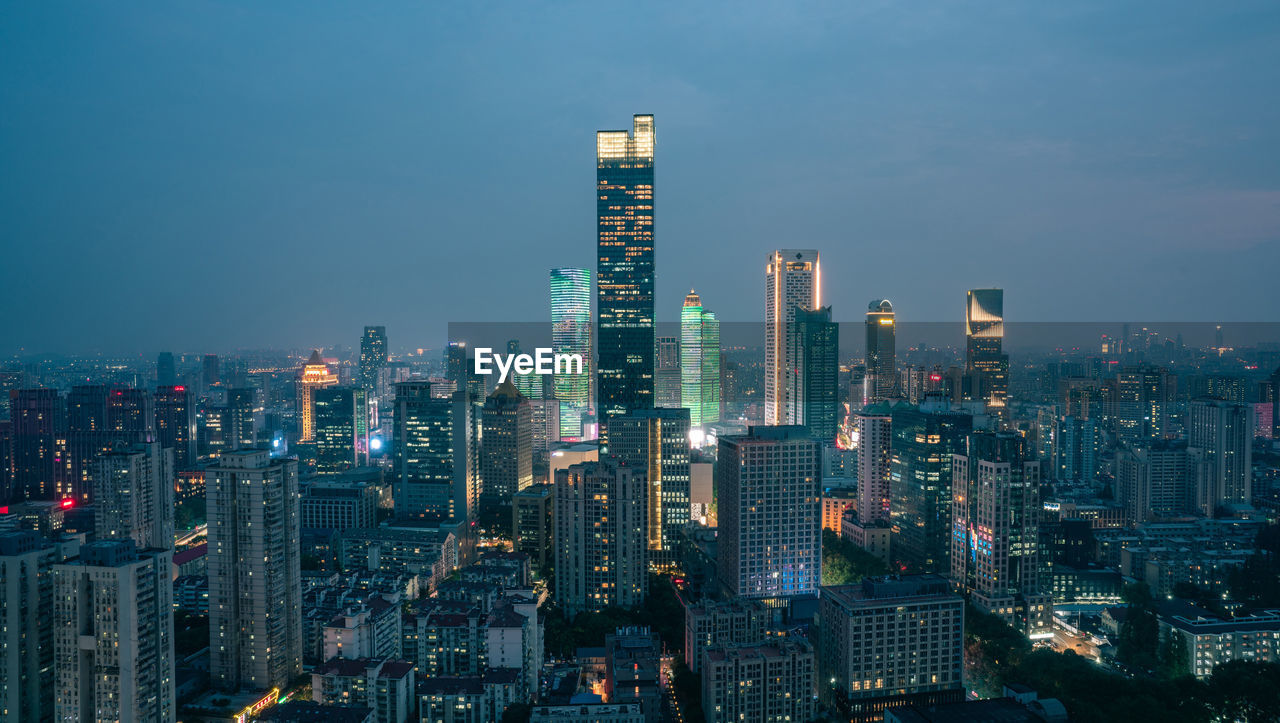 high angle view of city lit up at dusk