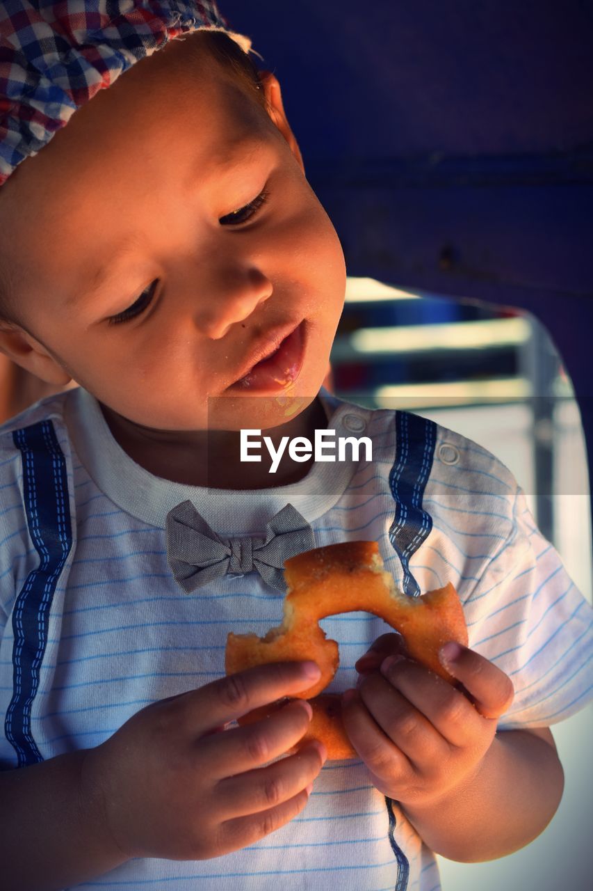 Close-up of boy holding food