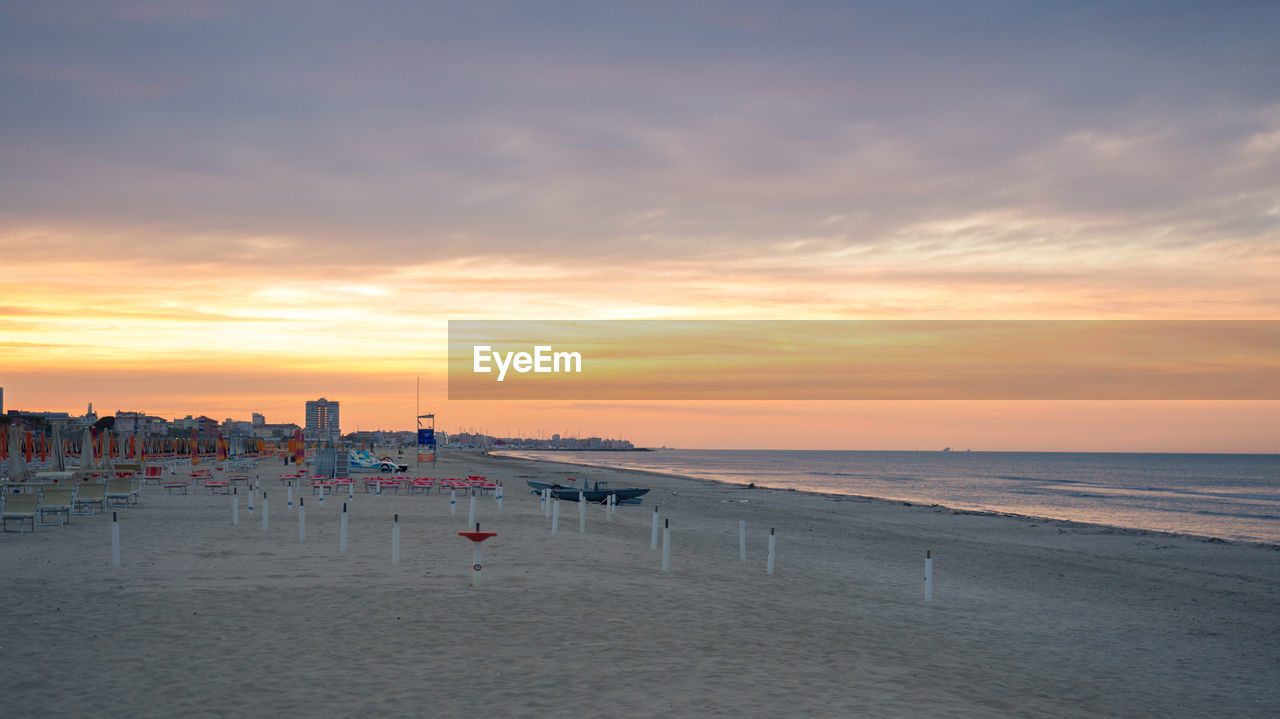 Scenic view of beach against sky during sunset