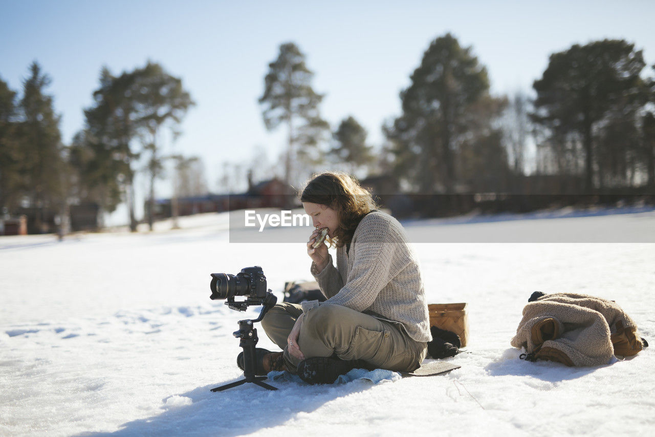 Photographer sitting on snow and relaxing