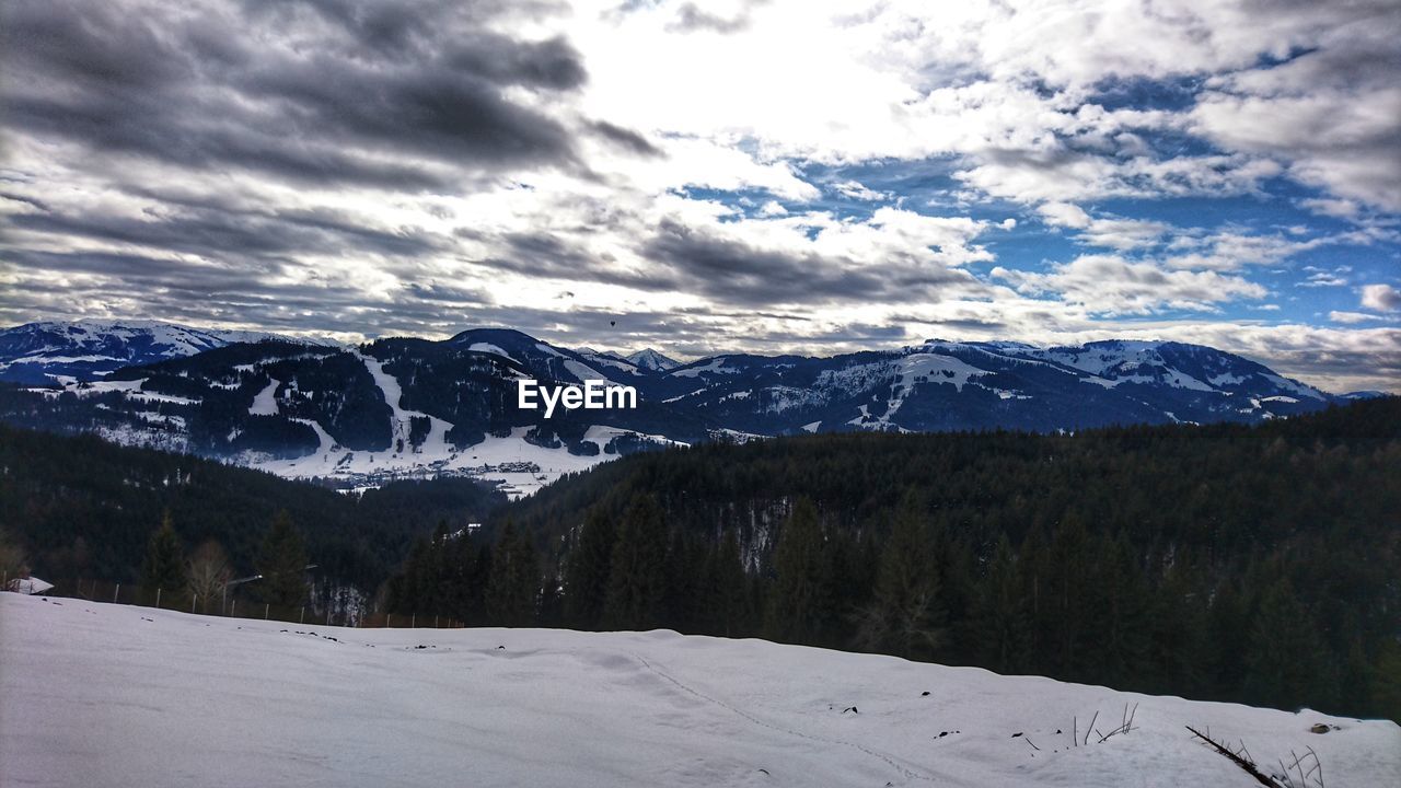 Scenic view of snow covered mountains against sky