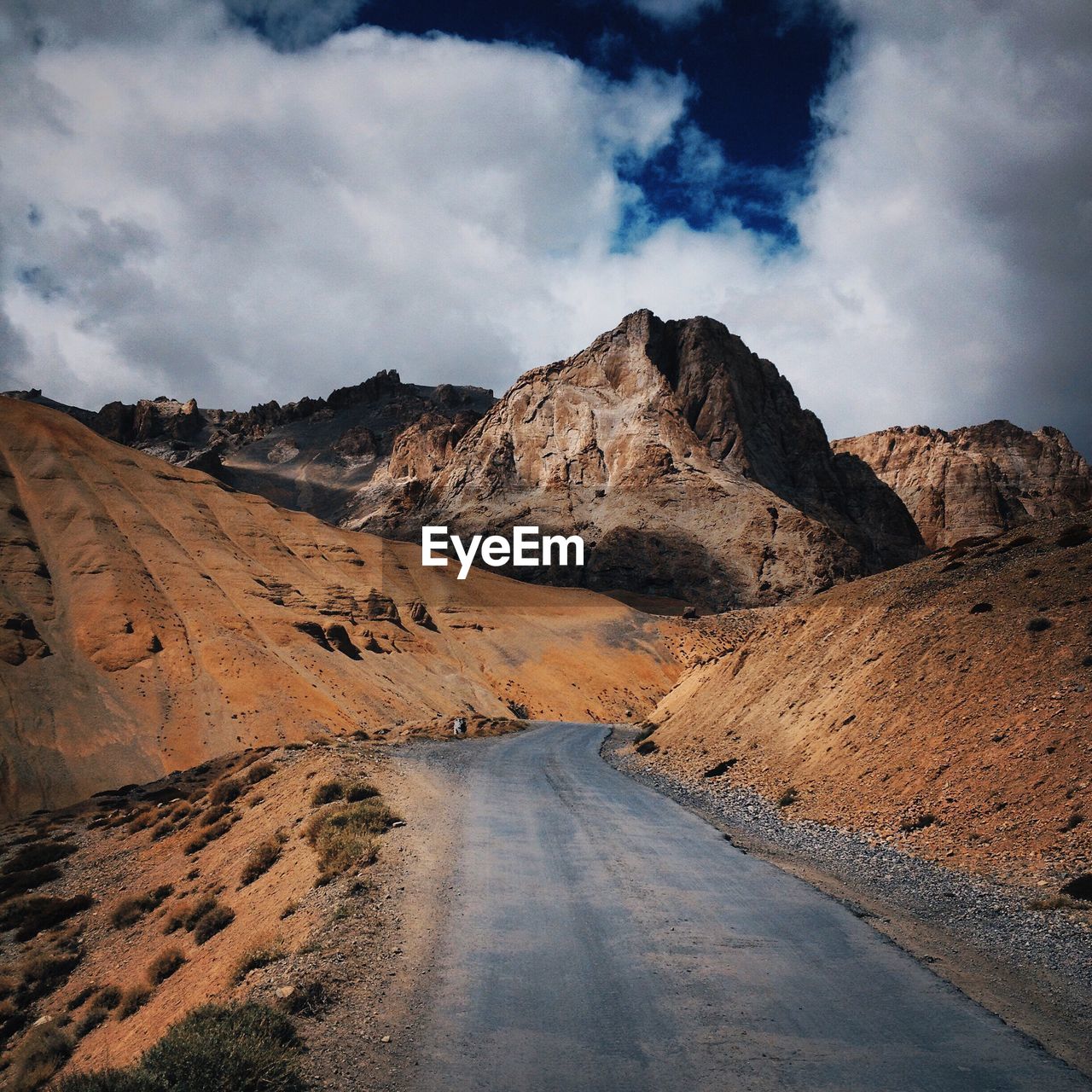 Scenic view of mountains against cloudy sky