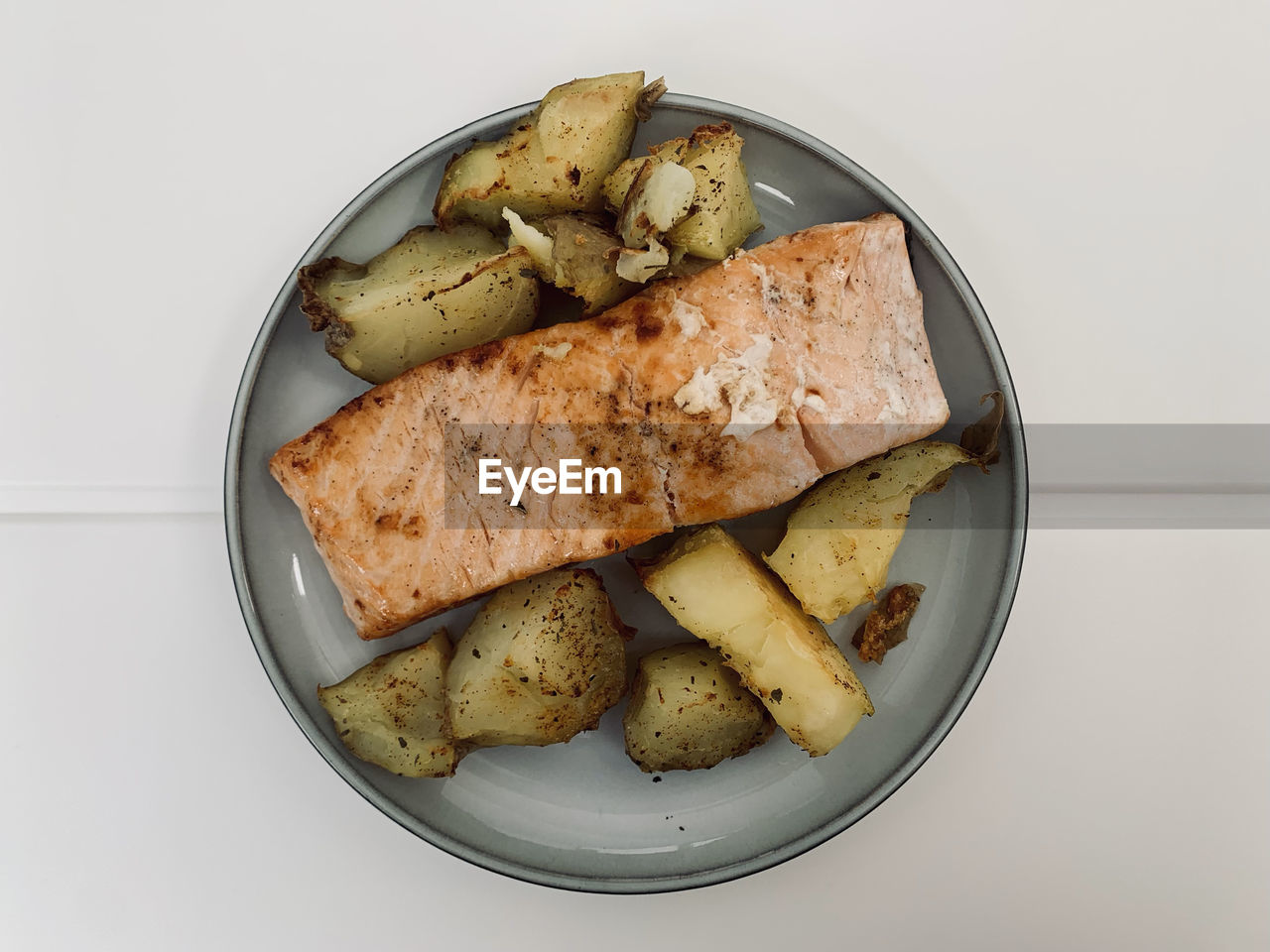 High angle view of salmon and potato in plate